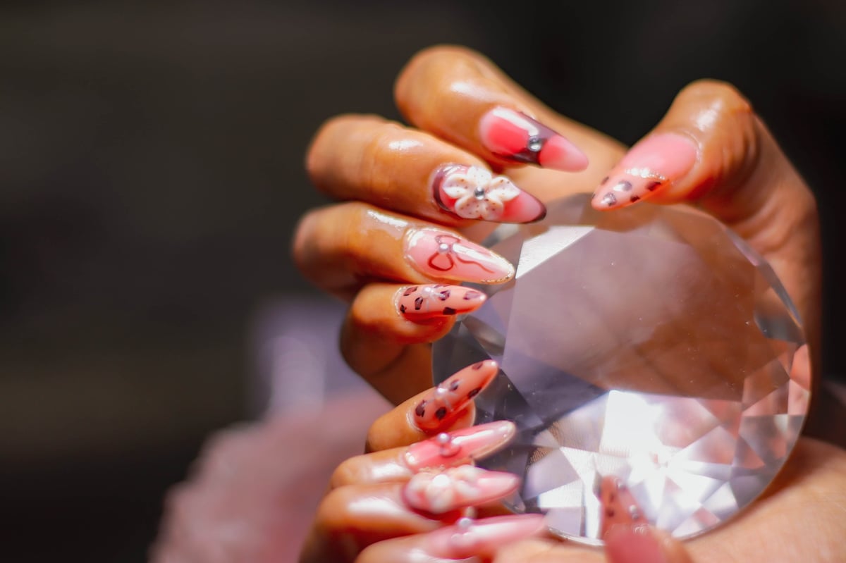 Nail technician providing a manicure to a client at a salon